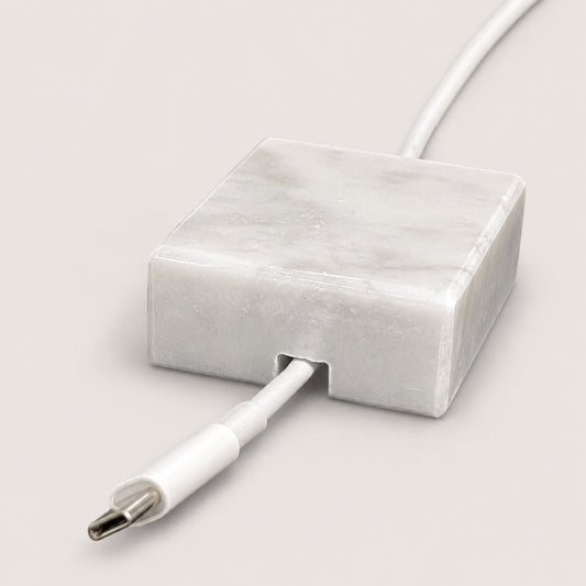 White Carrara Marble cord organizer with polished finish, single-cable slot