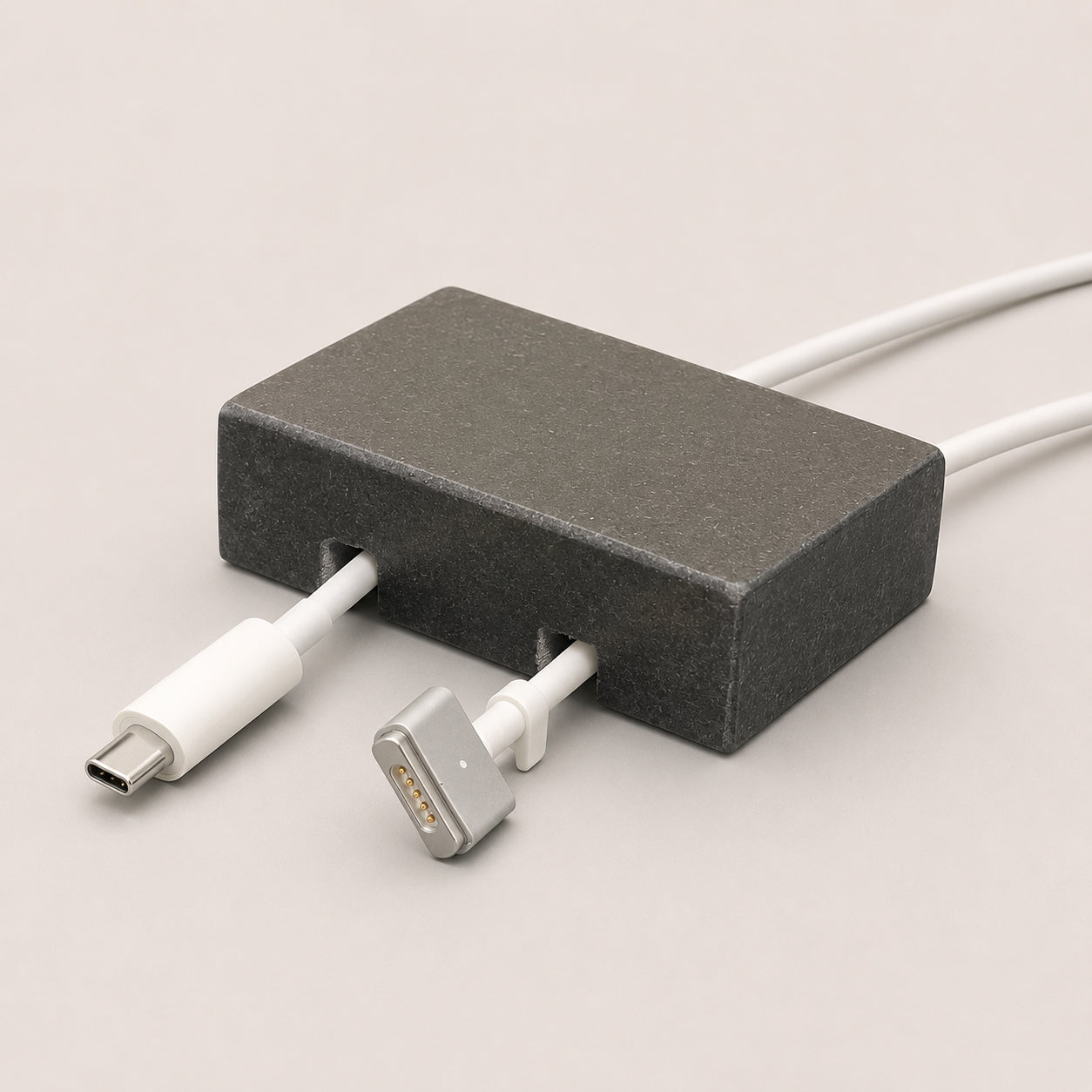 Black Granite cord organizer with honed finish, double-cable slot