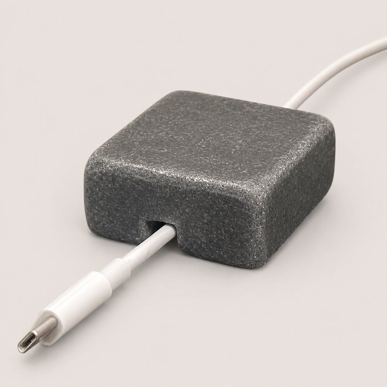 Black Granite cord organizer with tumbled finish, single-cable slot