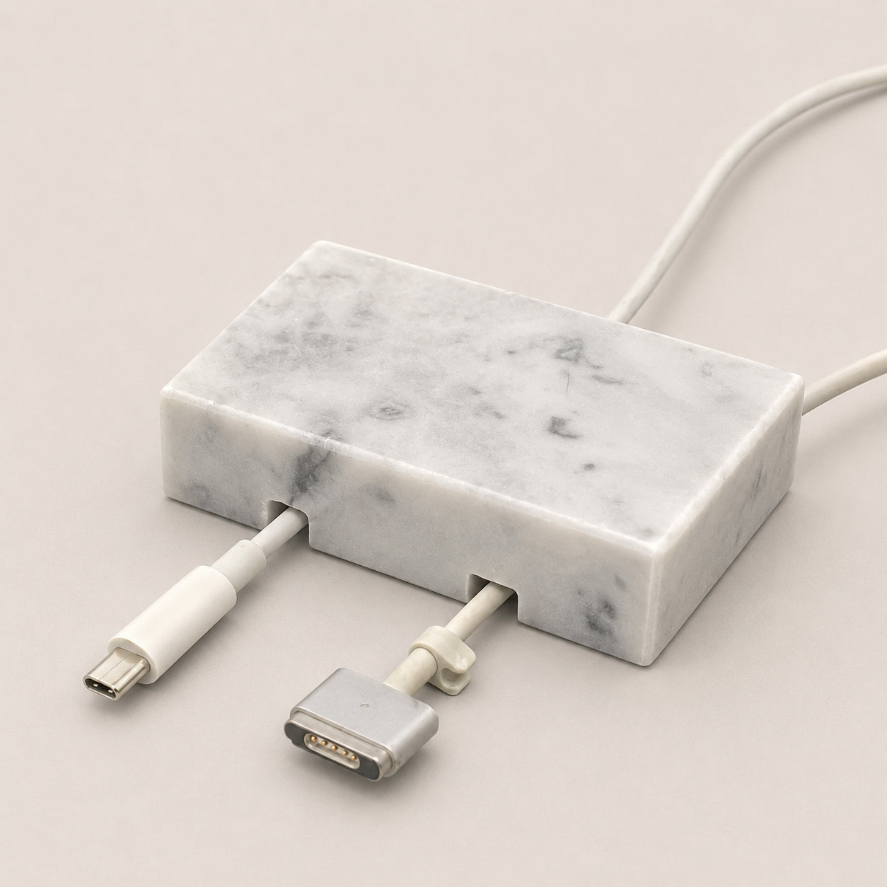 White Carrara Marble cord organizer with polished finish, double-cable slot