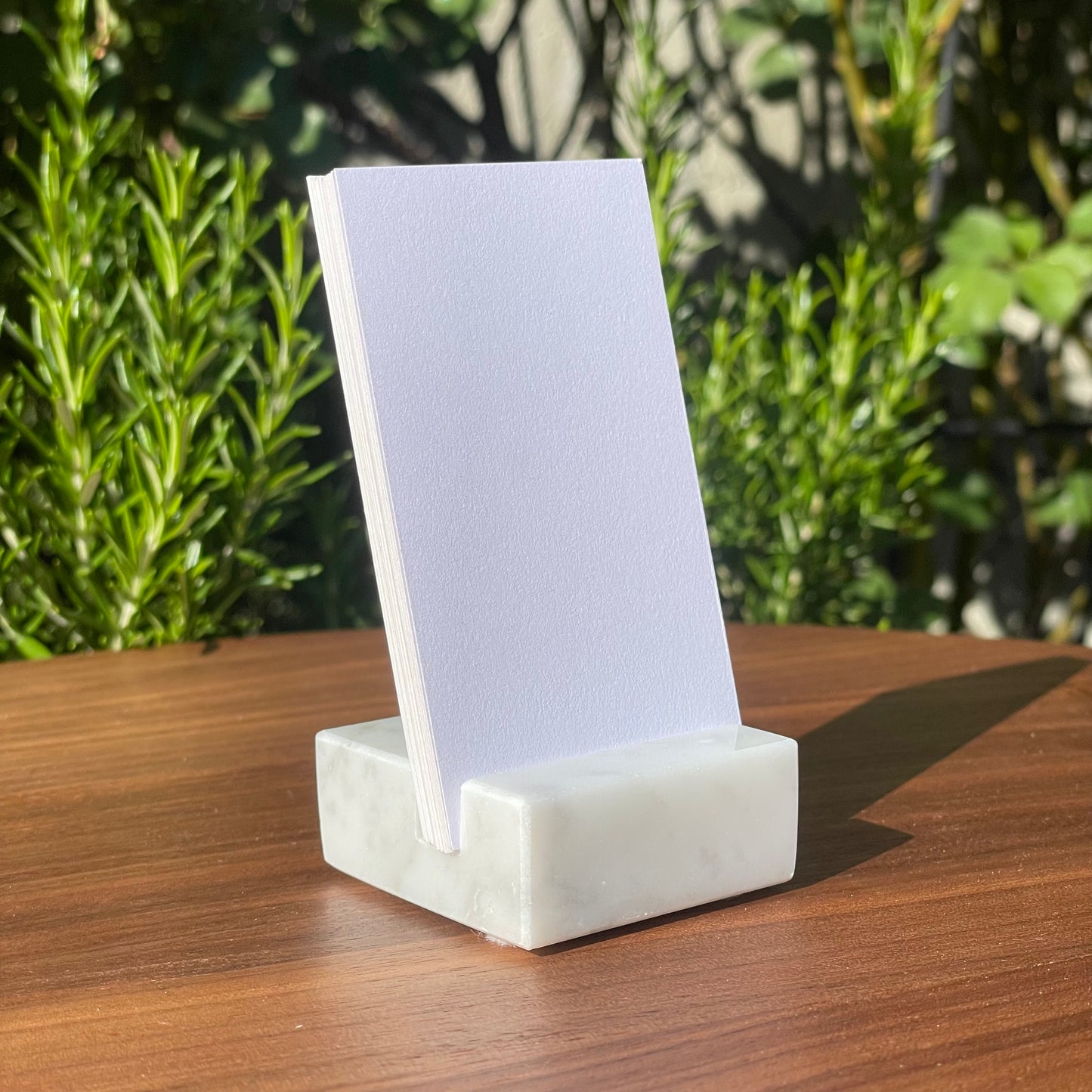 White Carrara Marble vertical business card holder on desk
