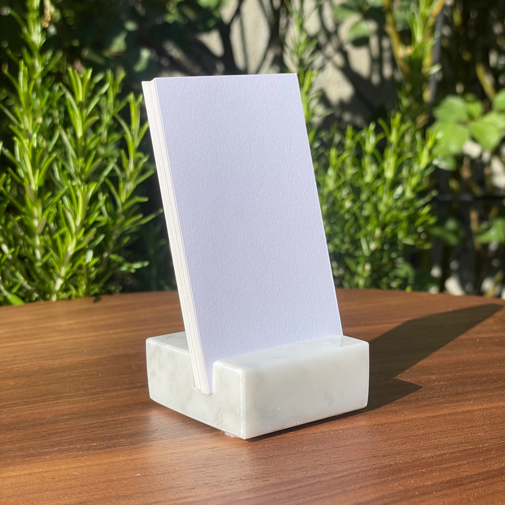White Carrara Marble vertical business card holder on desk
