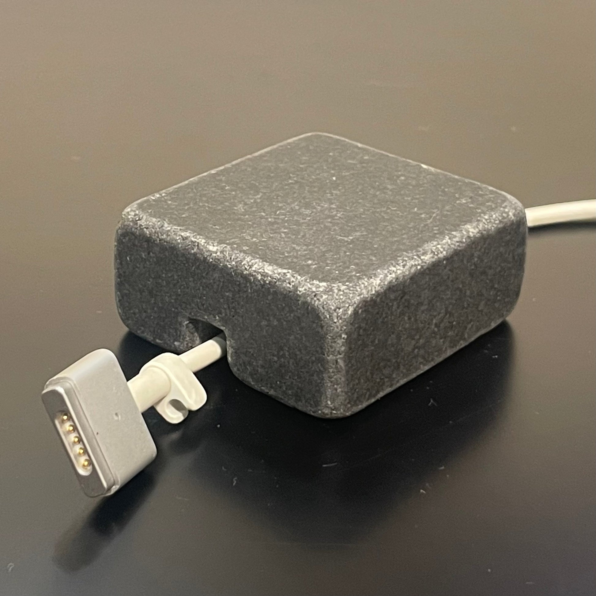 Black Granite cord organizer with tumbled finish, single-cable slot