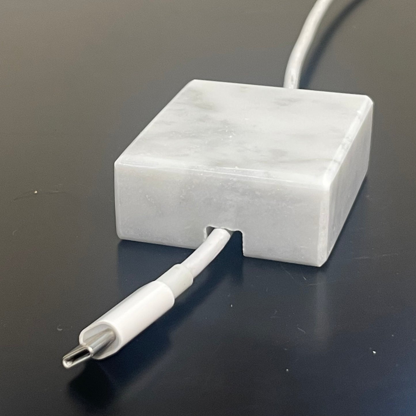 White Carrara Marble cord organizer with polished finish, single-cable slot