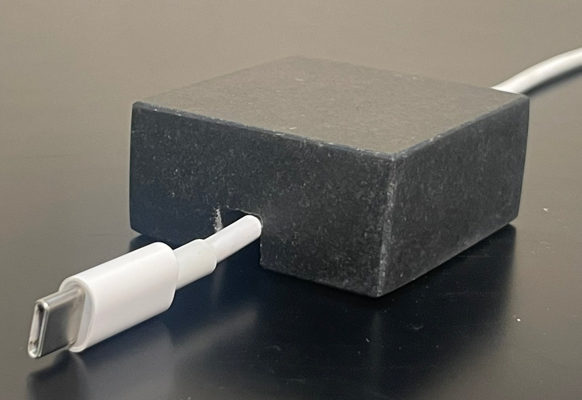 Black Granite cord organizer with honed finish, single-cable slot