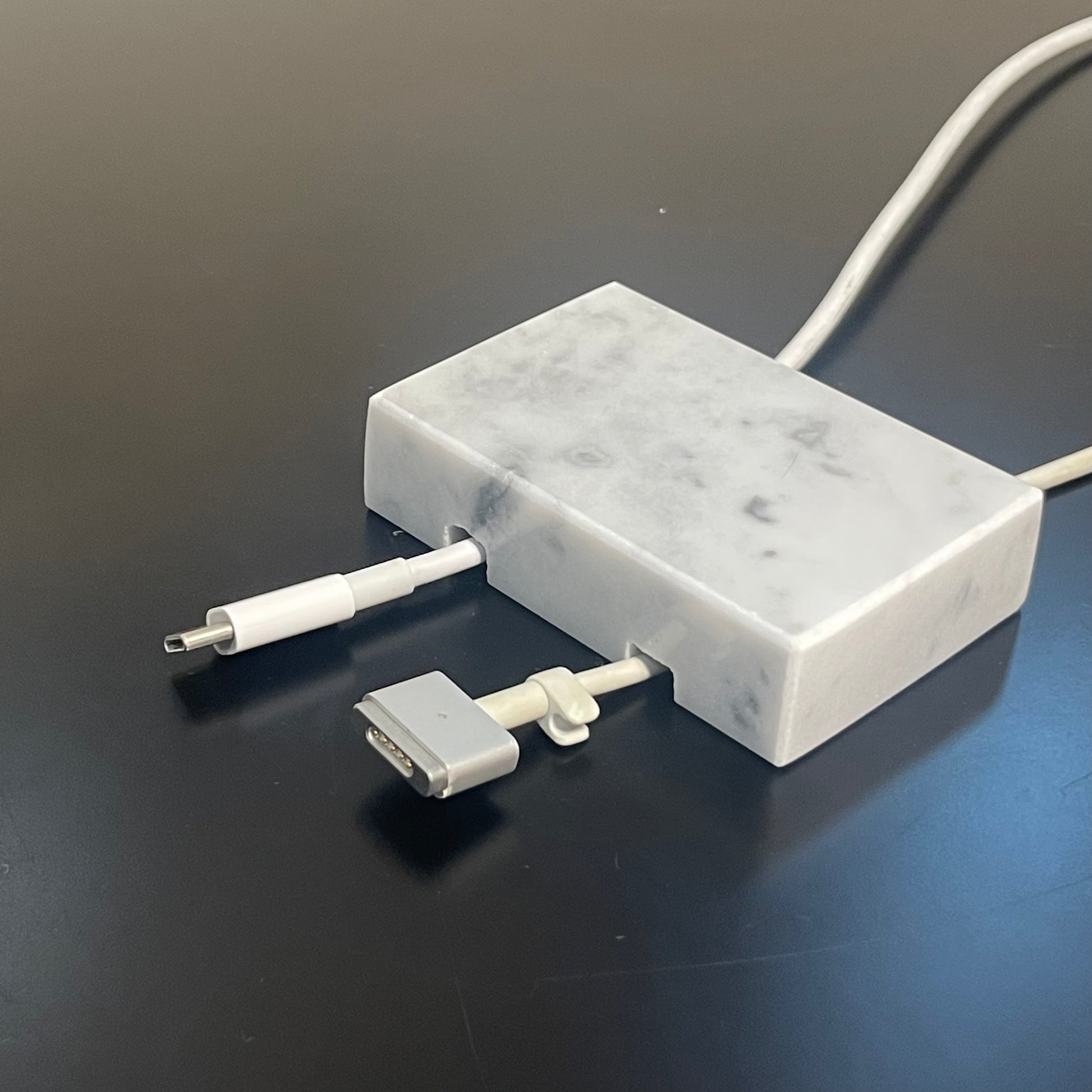 White Carrara Marble cord organizer with polished finish, double-cable slot
