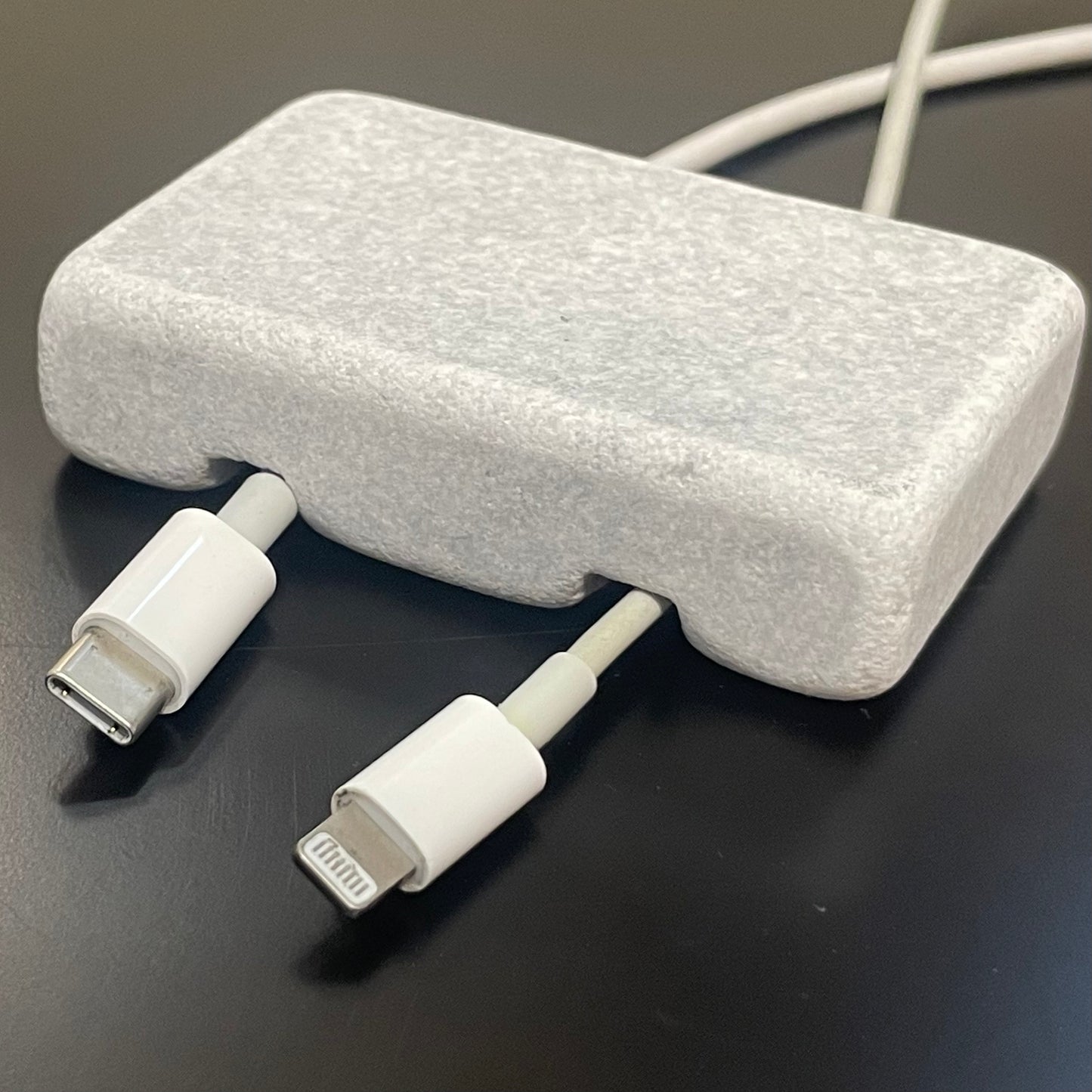 White Carrara Marble cord organizer with tumbled finish, double-cable slot
