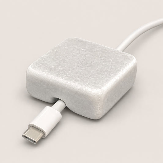 White Carrara Marble cord organizer with tumbled finish, single-cable slot